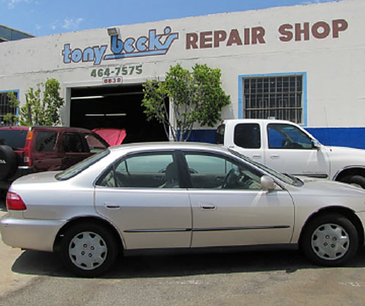 Silver sedan in front of the shop